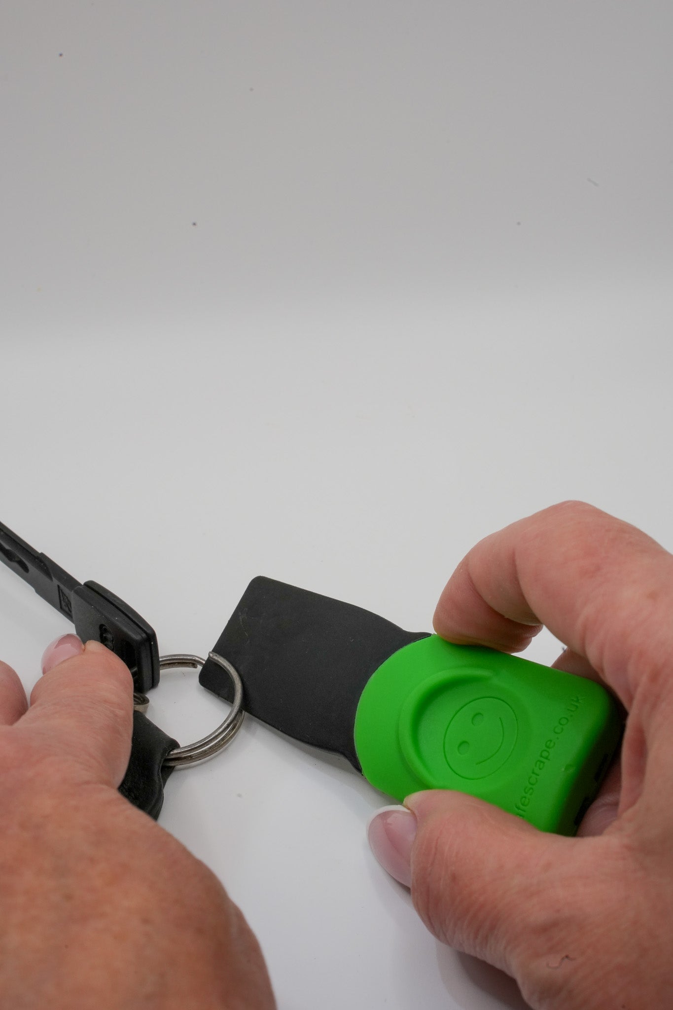 SafeScrape plastic scraper opening a keyring easily